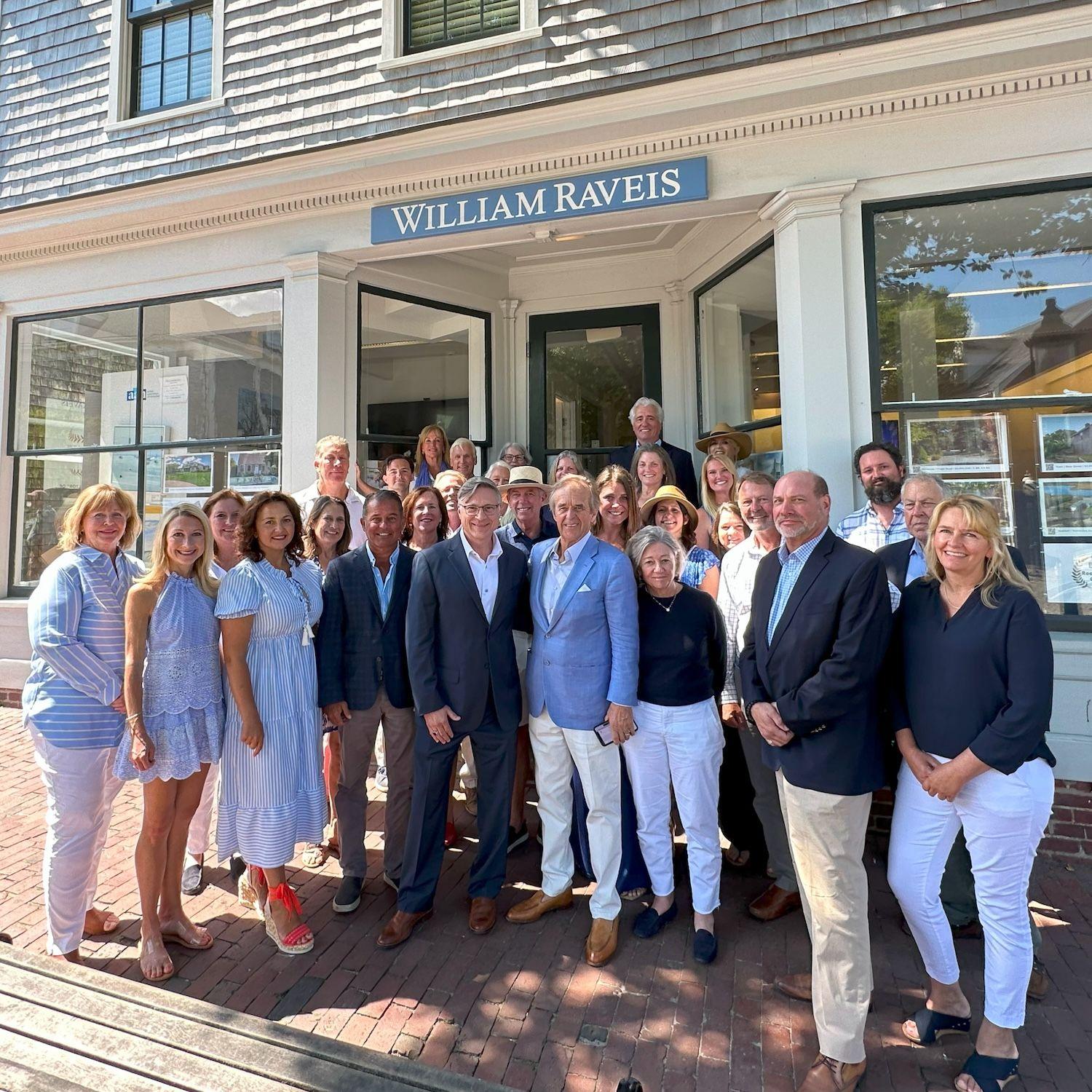 Group of William Raveis Nantucket agents standing outside the office.