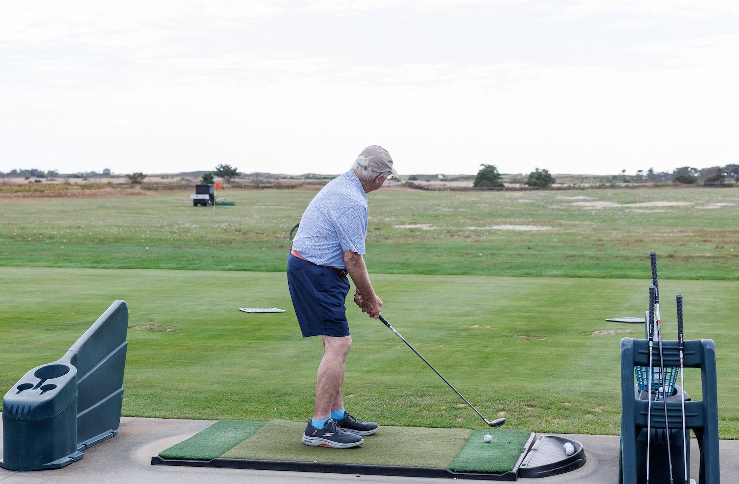Man at driving range at Miacomet Golf Course.