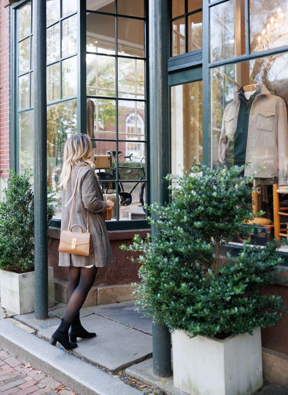 Woman window shopping along street in Nantucket.