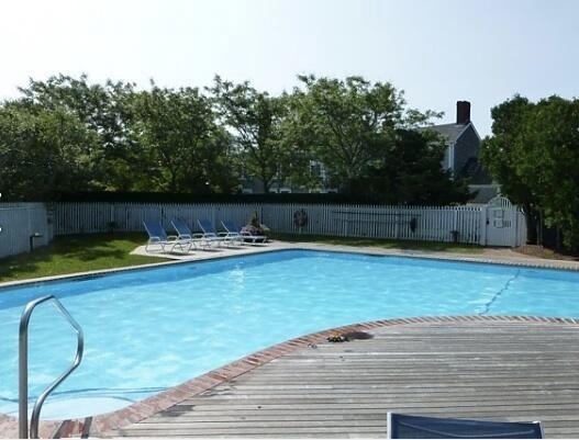 In-ground pool with fence around it.